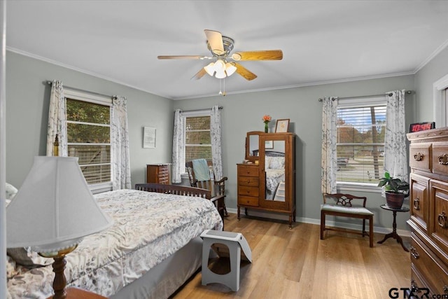 bedroom featuring light hardwood / wood-style flooring, ceiling fan, and ornamental molding