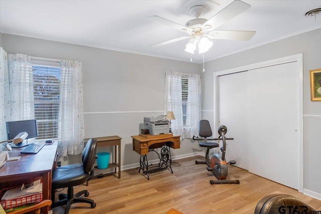 home office featuring light wood-type flooring, plenty of natural light, and ornamental molding