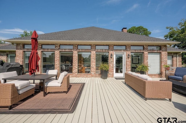 wooden terrace with outdoor lounge area