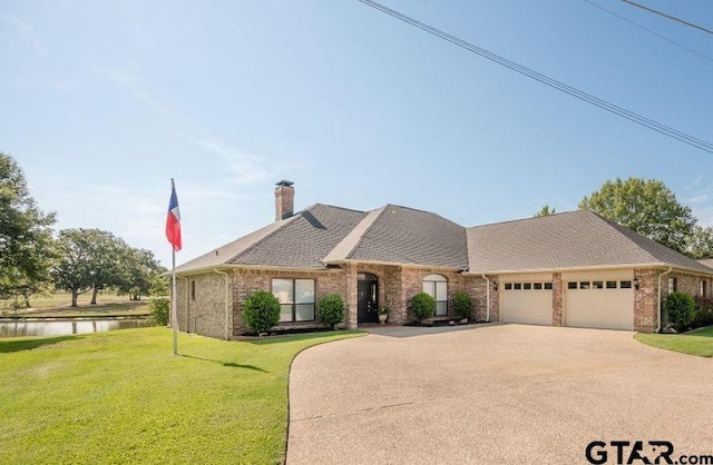 view of front of home featuring brick siding, a front yard, a chimney, a garage, and driveway