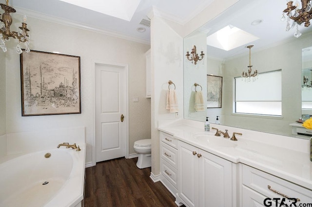 full bathroom featuring vanity, an inviting chandelier, a skylight, crown molding, and toilet