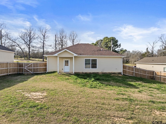 rear view of house with a lawn