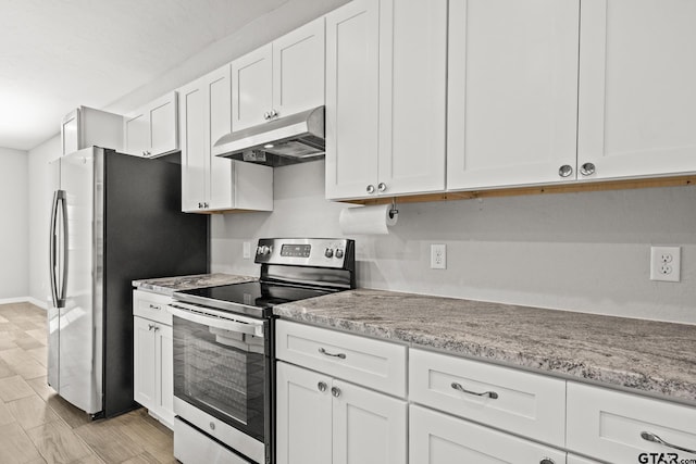 kitchen featuring white cabinets, light stone counters, and appliances with stainless steel finishes