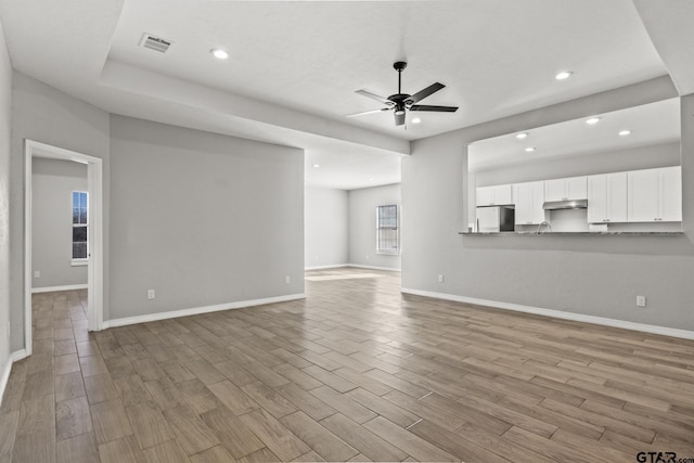 unfurnished living room with ceiling fan