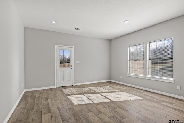 spare room featuring light hardwood / wood-style flooring