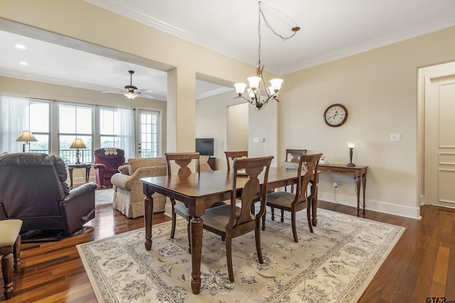 dining space featuring ceiling fan with notable chandelier, crown molding, and dark hardwood / wood-style flooring