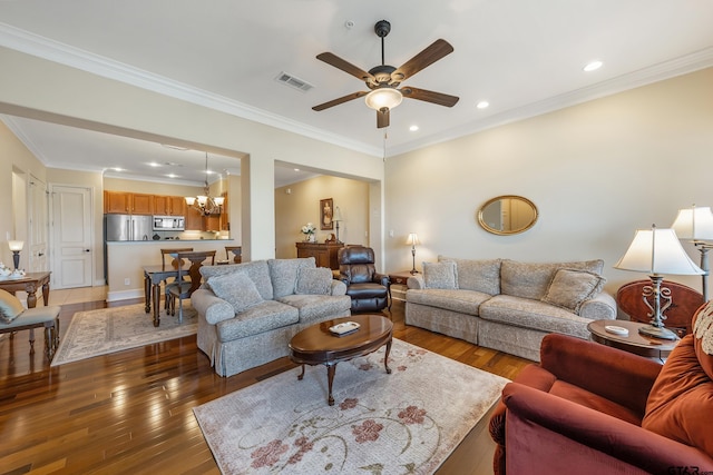 living room with ornamental molding, ceiling fan with notable chandelier, and dark wood-type flooring