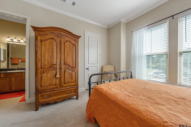 bedroom with ornamental molding, ensuite bath, sink, and light colored carpet