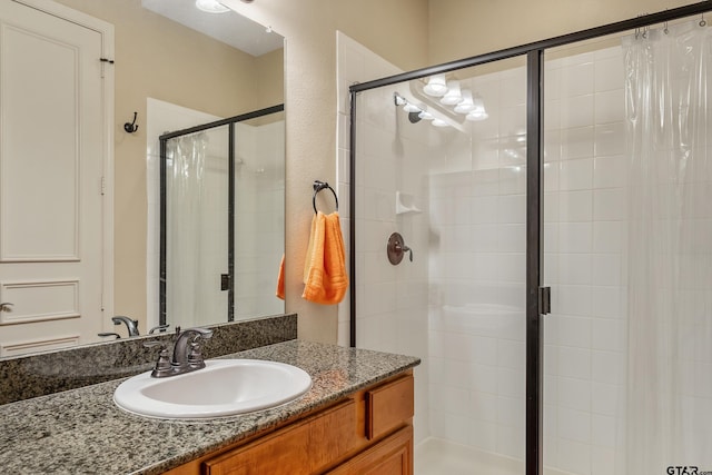 bathroom featuring vanity and a shower with shower door