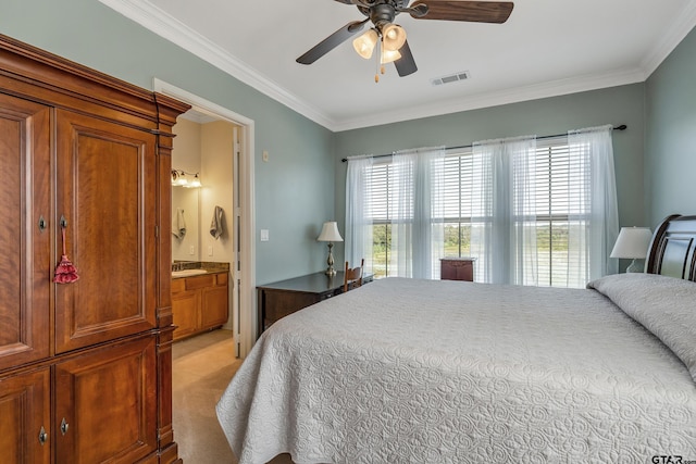 bedroom with ceiling fan, multiple windows, light carpet, and connected bathroom