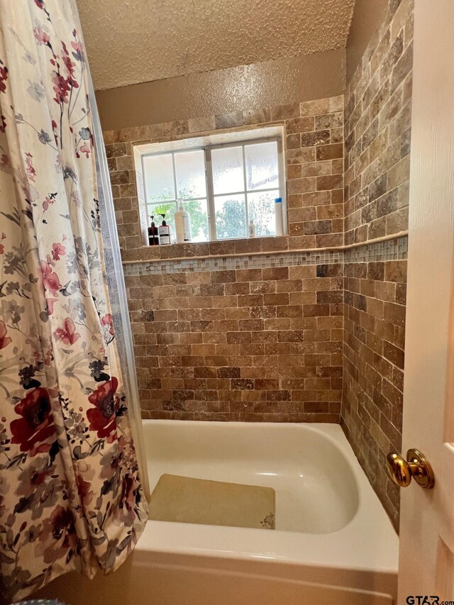 2000 Homestead Dr, Mesquite, TX 75181 - bathroom featuring shower / tub combo and a textured ceiling