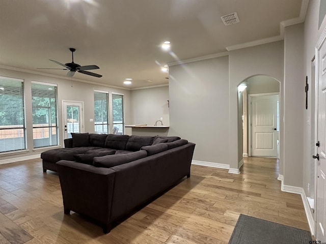 2509 Guinn Farms Rd, Tyler, TX 75707 - living area featuring arched walkways, crown molding, a ceiling fan, light wood-type flooring, and recessed lighting