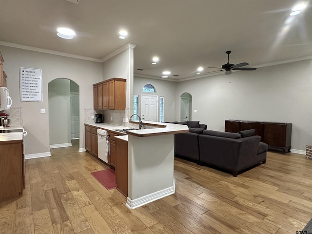 2509 Guinn Farms Rd, Tyler, TX 75707 - kitchen featuring arched walkways, white appliances, a ceiling fan, light countertops, and crown molding