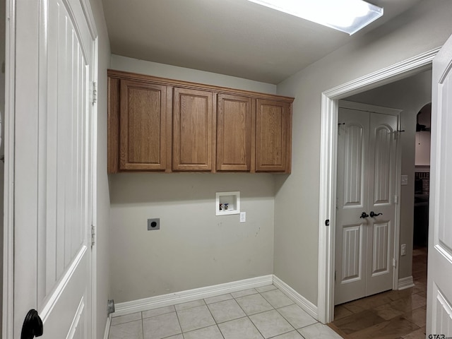 2509 Guinn Farms Rd, Tyler, TX 75707 - washroom featuring hookup for an electric dryer, washer hookup, light tile patterned floors, cabinet space, and arched walkways