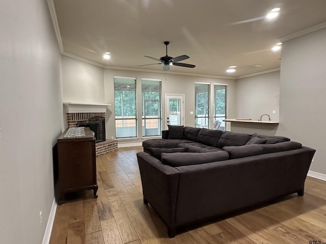 2509 Guinn Farms Rd, Tyler, TX 75707 - living room with ornamental molding, hardwood / wood-style floors, a brick fireplace, ceiling fan, and recessed lighting