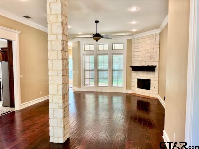 3673 Southwood Dr, Tyler, TX 75707 - unfurnished living room featuring ceiling fan, ornamental molding, decorative columns, and dark wood-style flooring
