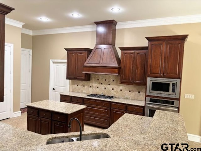 3673 Southwood Dr, Tyler, TX 75707 - kitchen with a kitchen island, built in microwave, a sink, premium range hood, and stainless steel oven