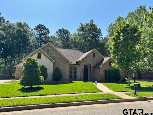 3673 Southwood Dr, Tyler, TX 75707 - view of front facade featuring a front yard and stone siding