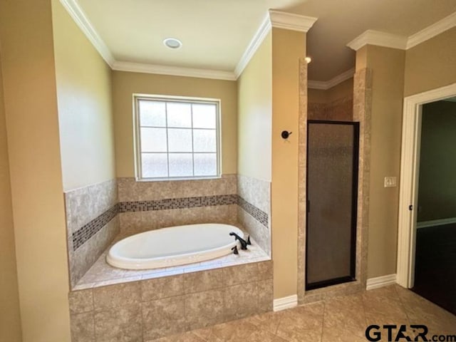 3673 Southwood Dr, Tyler, TX 75707 - bathroom with tile patterned floors, ornamental molding, a stall shower, and a bath