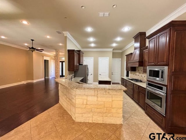 3673 Southwood Dr, Tyler, TX 75707 - kitchen with stainless steel appliances, recessed lighting, and dark brown cabinets