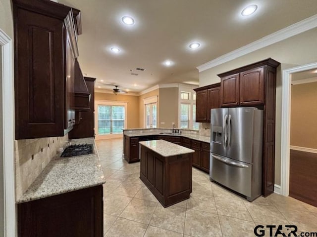 3673 Southwood Dr, Tyler, TX 75707 - kitchen featuring stainless steel appliances, ornamental molding, a sink, and tasteful backsplash
