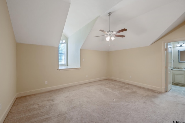 bonus room with light colored carpet, ceiling fan, and lofted ceiling