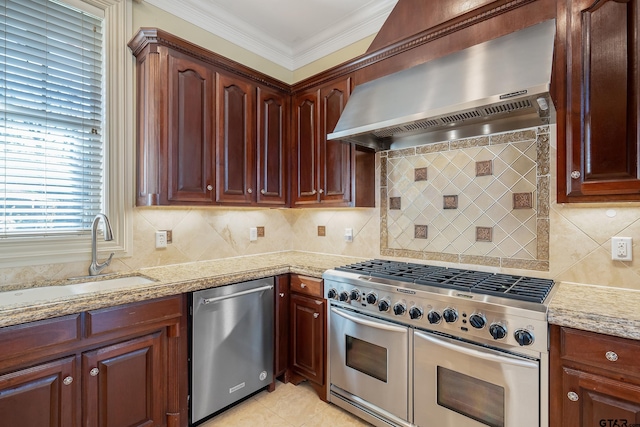 kitchen with backsplash, sink, wall chimney exhaust hood, and appliances with stainless steel finishes