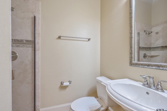 bathroom with toilet, sink, and walk in shower