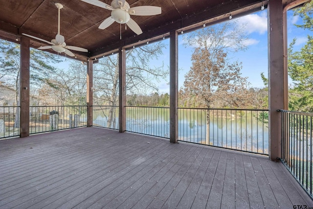 wooden deck with ceiling fan and a water view