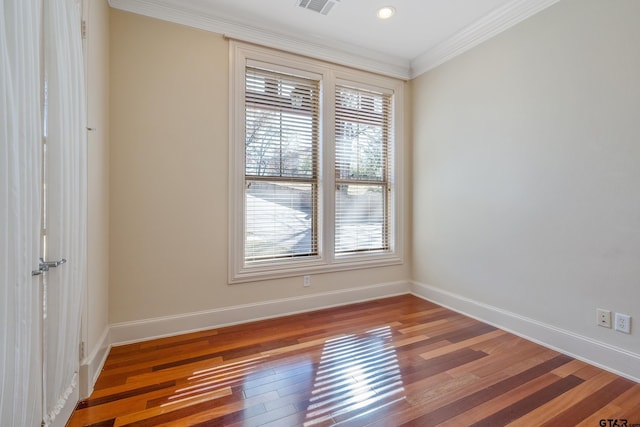 unfurnished room with hardwood / wood-style floors and ornamental molding