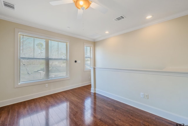 spare room featuring dark hardwood / wood-style flooring and crown molding