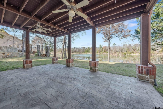 view of patio with ceiling fan and a water view