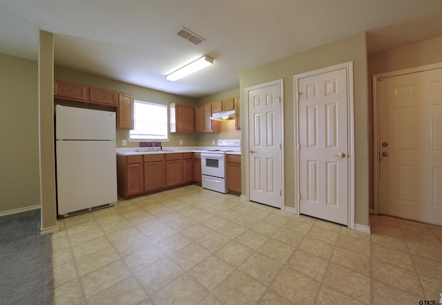 kitchen featuring white appliances and sink