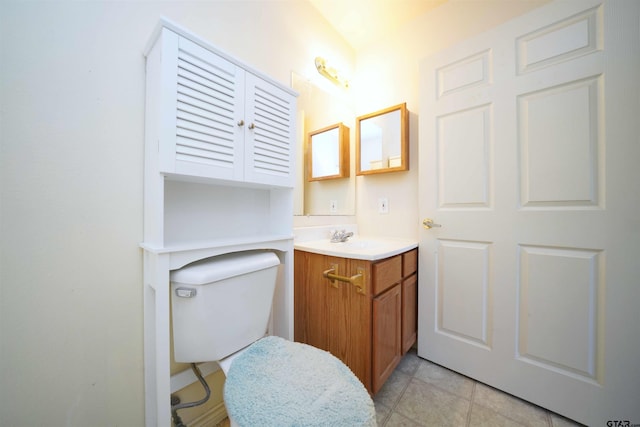 bathroom featuring toilet, vanity, and tile patterned floors