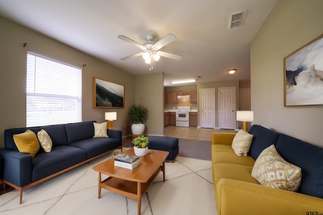 tiled living room featuring ceiling fan