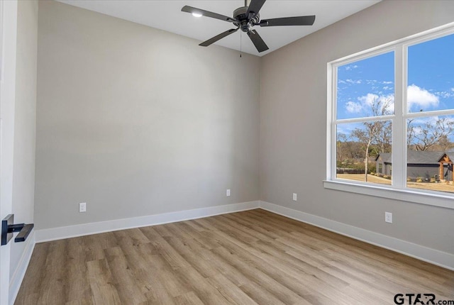 empty room with ceiling fan and light wood-type flooring