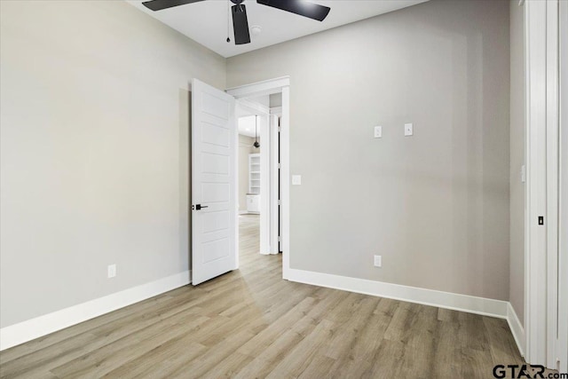 unfurnished bedroom with ceiling fan and light wood-type flooring