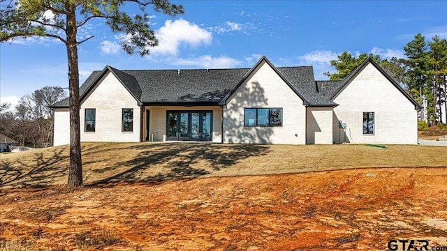 rear view of property featuring a lawn