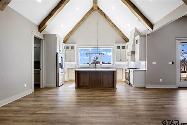 kitchen with tasteful backsplash, decorative light fixtures, a center island, high vaulted ceiling, and stainless steel appliances