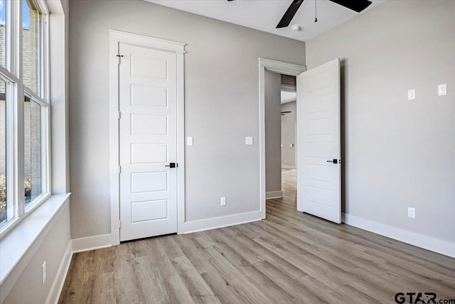 unfurnished bedroom with ceiling fan and light hardwood / wood-style flooring