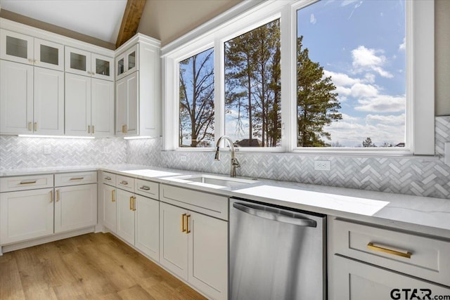 kitchen featuring sink, light hardwood / wood-style flooring, dishwasher, white cabinetry, and light stone counters