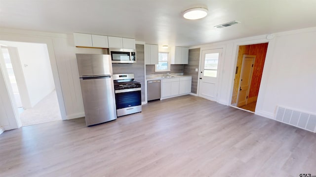 kitchen with light countertops, visible vents, white cabinets, and appliances with stainless steel finishes