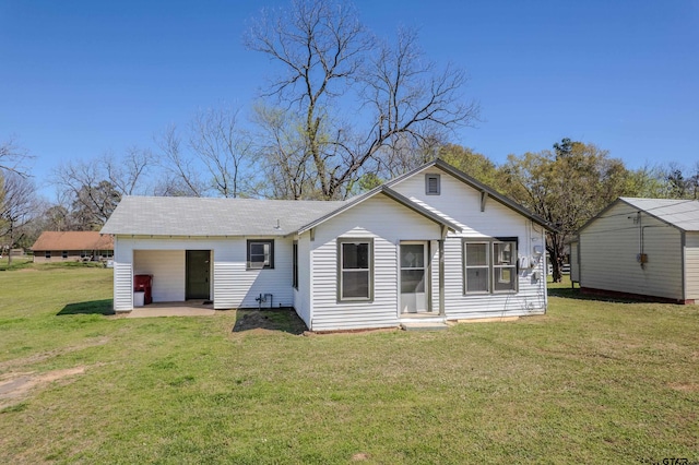 back of house with a lawn and a patio area