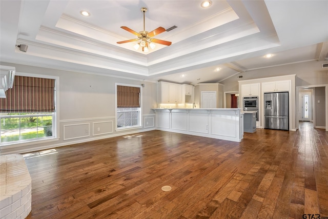 unfurnished living room featuring dark hardwood / wood-style floors, ceiling fan, and crown molding