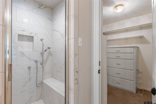 bathroom with tiled shower