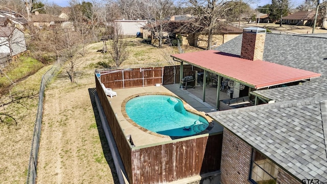 view of swimming pool featuring a fenced in pool, a patio area, a lawn, and a fenced backyard