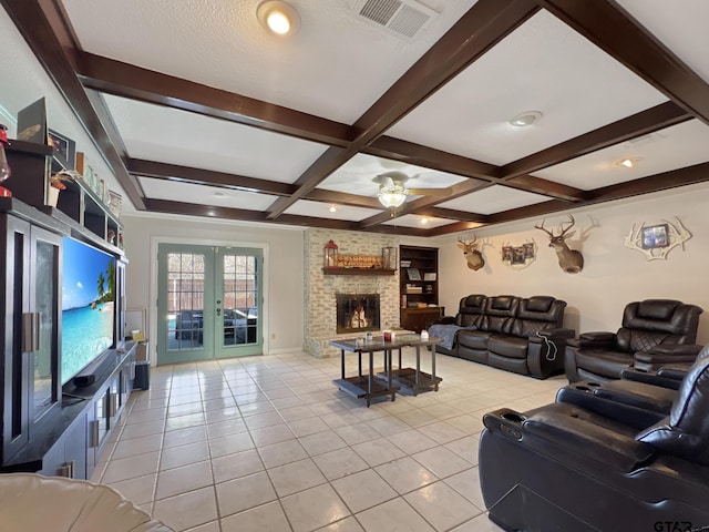 living room featuring visible vents, french doors, a fireplace, beam ceiling, and light tile patterned flooring