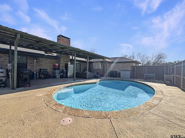 view of pool featuring a patio area, cooling unit, a fenced in pool, and fence