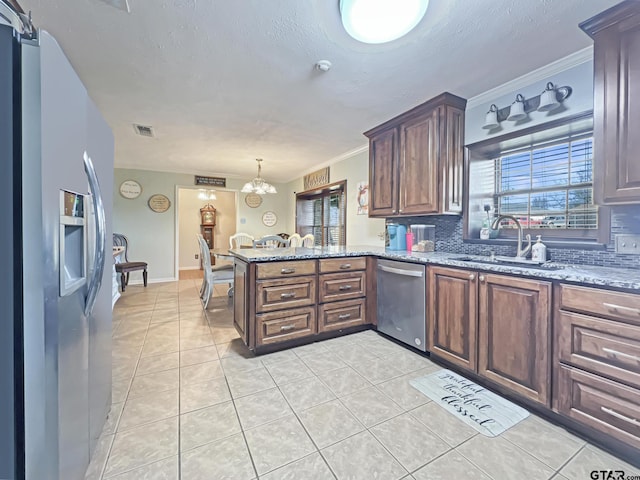 kitchen featuring tasteful backsplash, visible vents, appliances with stainless steel finishes, a peninsula, and light tile patterned flooring