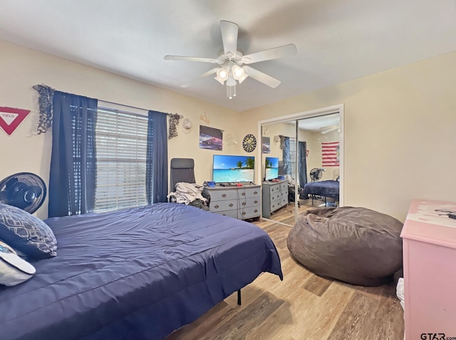 bedroom with a ceiling fan, a closet, and wood finished floors